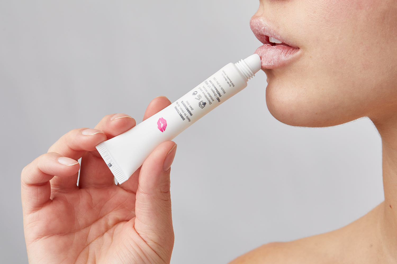 woman putting on lip serum