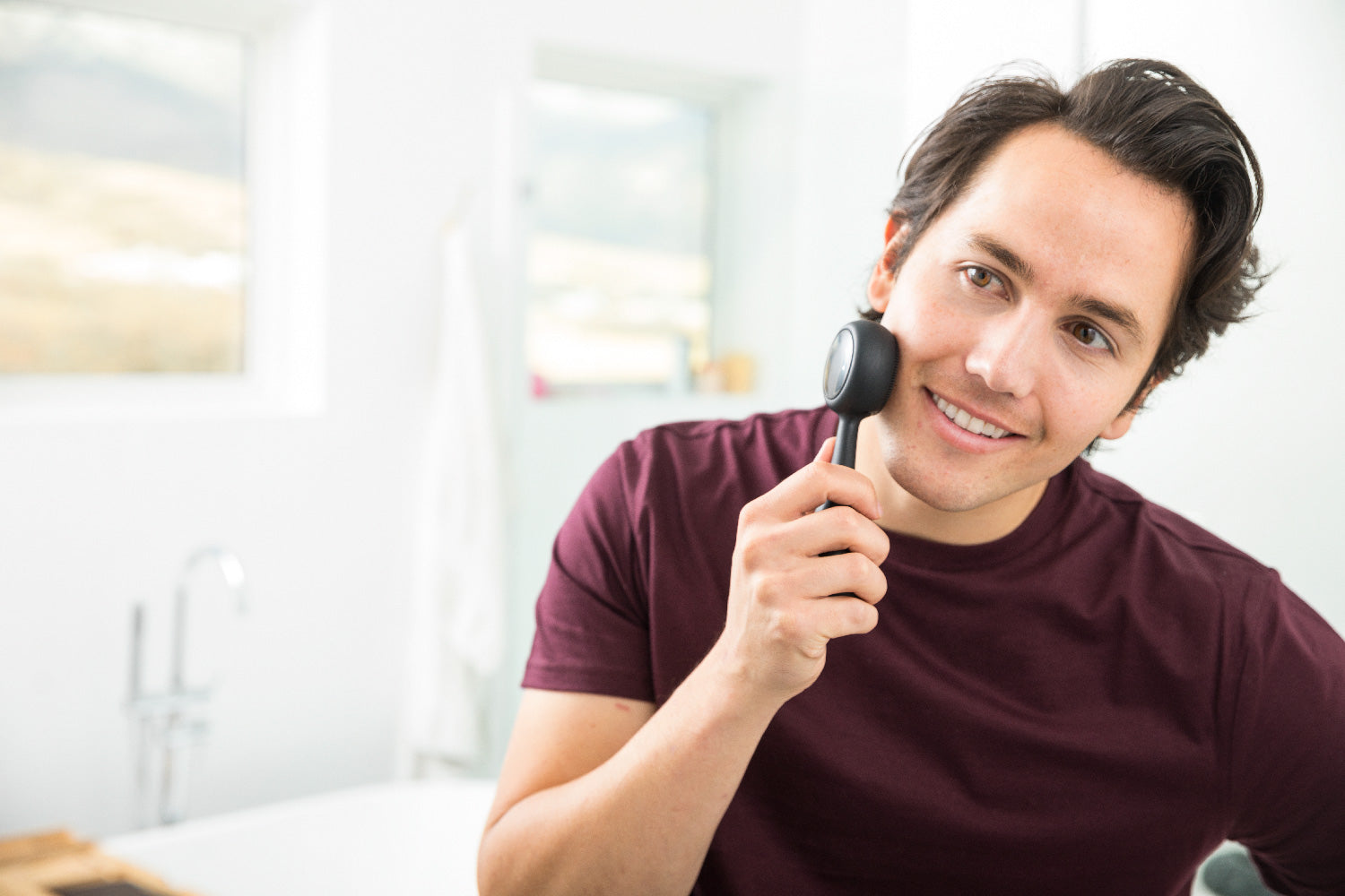 man using PMD Clean Pro OB to wash his face