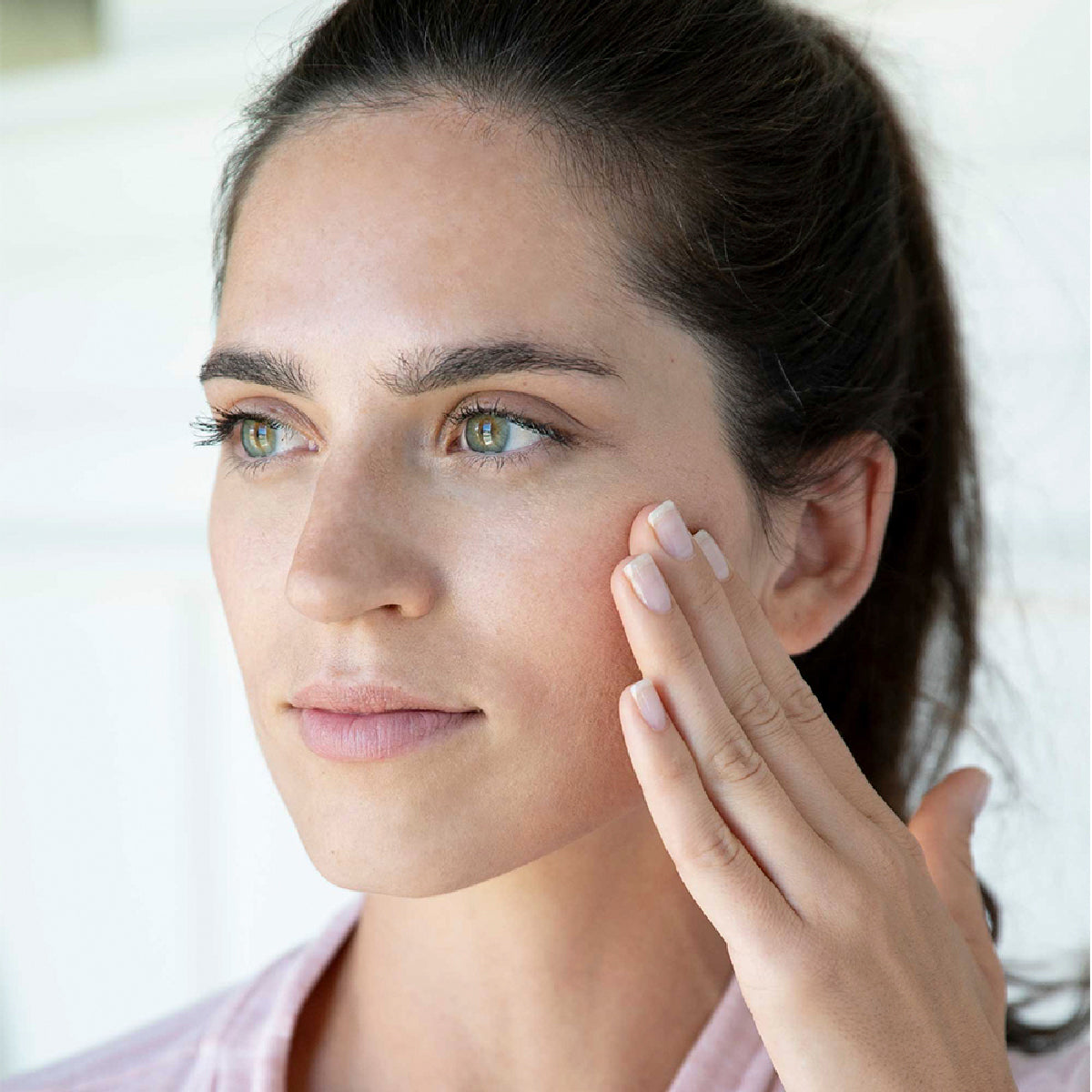 woman pulling skin taught on face