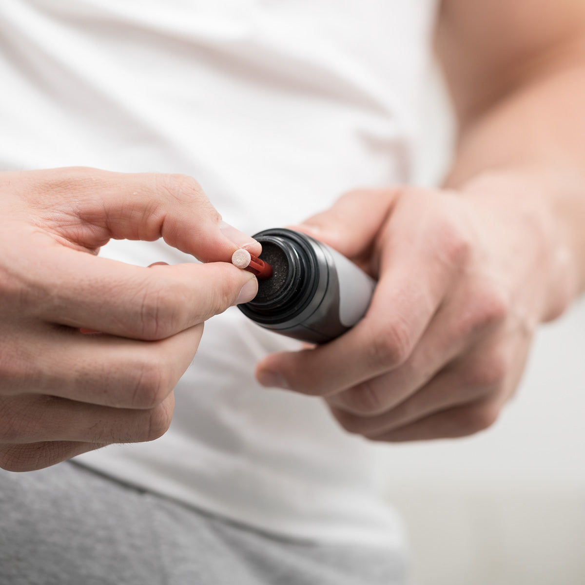 man placing red disc on personal microderm man
