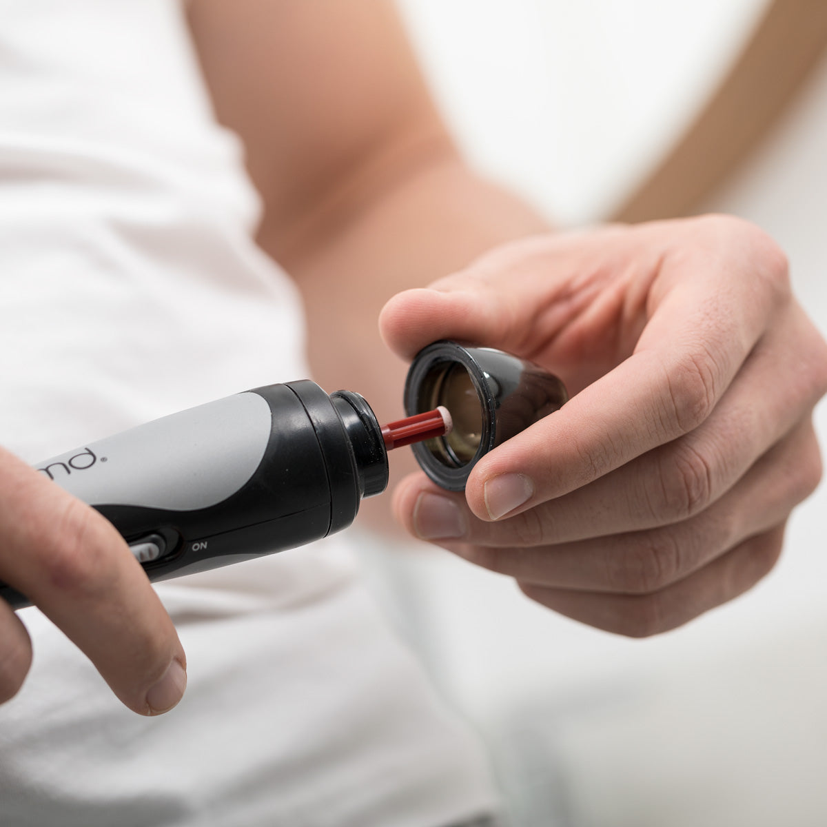 man placing cap on personal microderm man