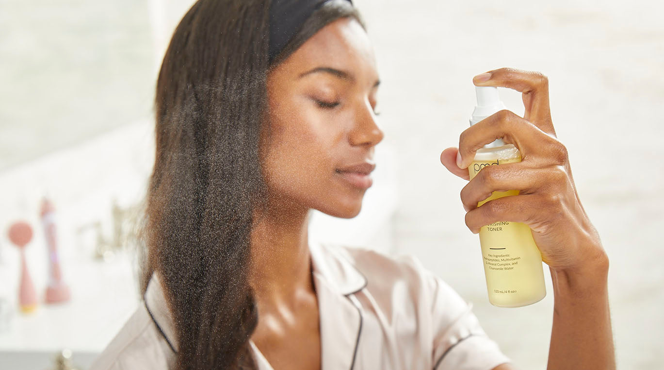 women spraying soothe on face