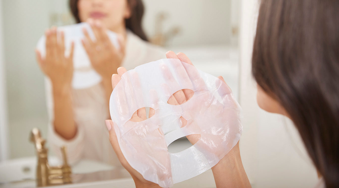 woman holding sheet mask