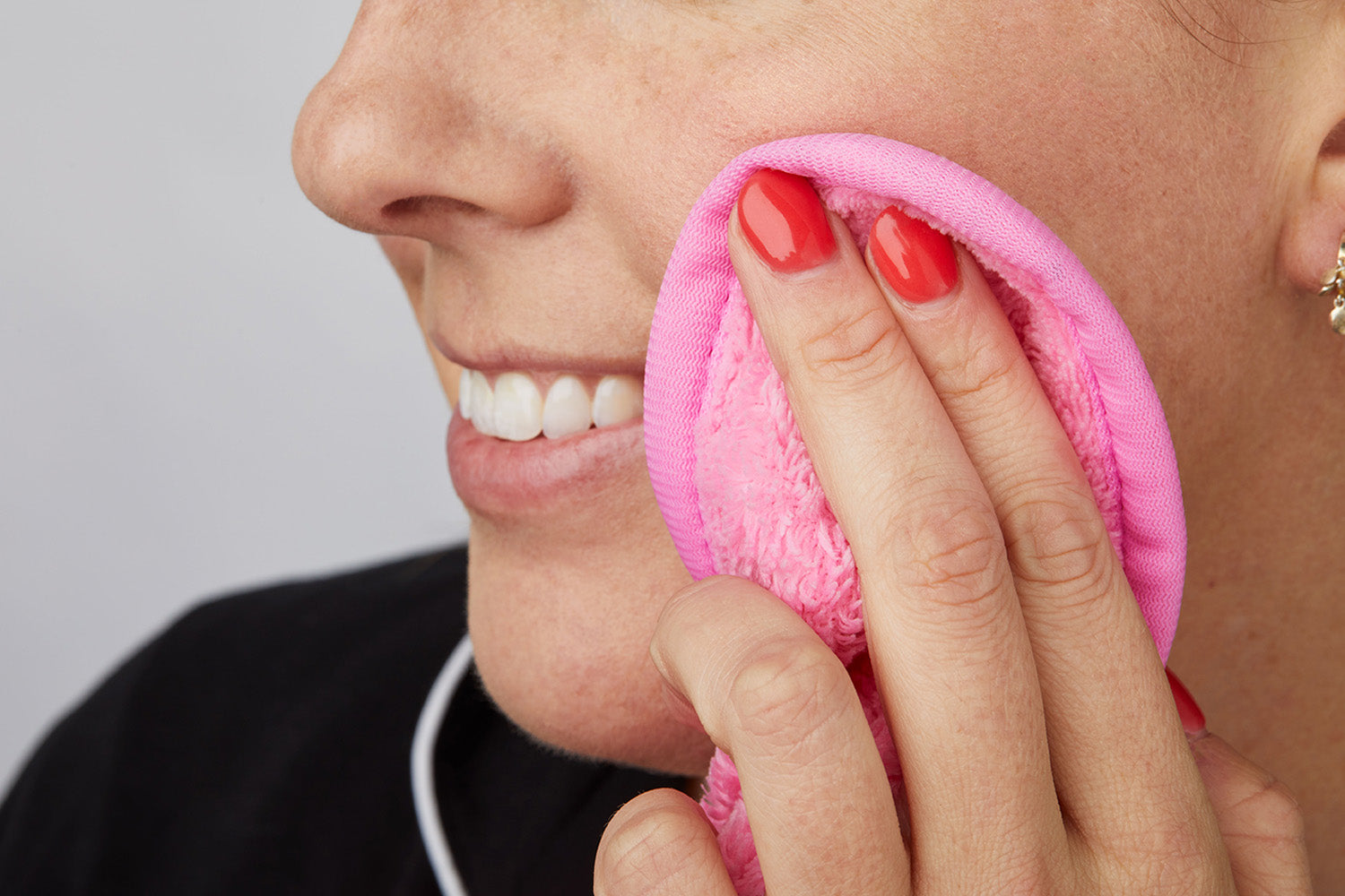 woman using silverase cloth on cheek