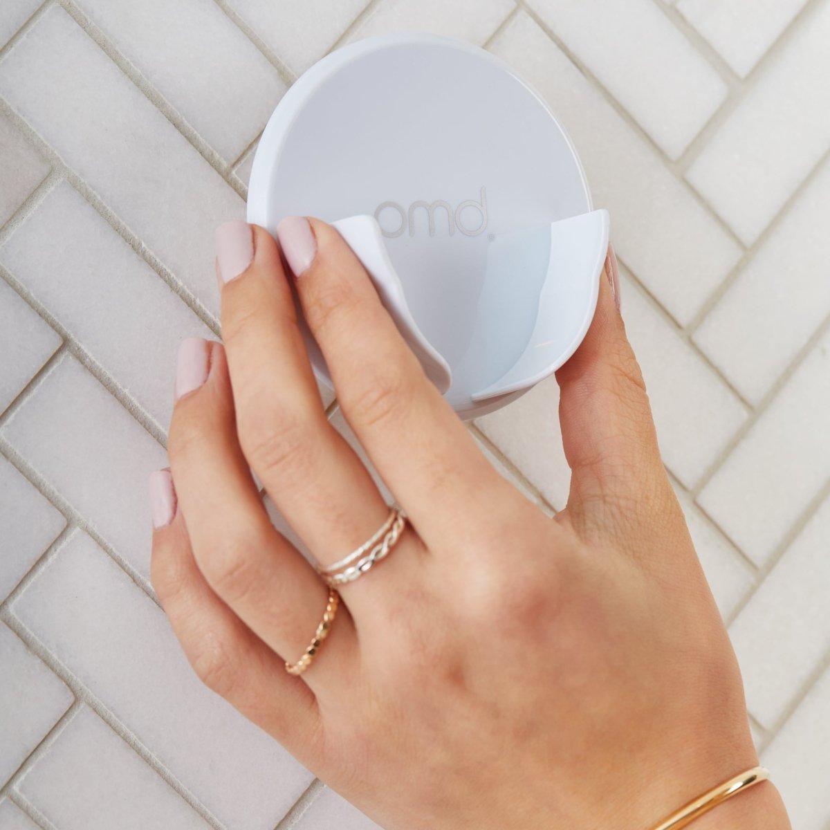 4002-Holder?Woman placing PMD Clean & Clean Pro Shower Holder on to shower