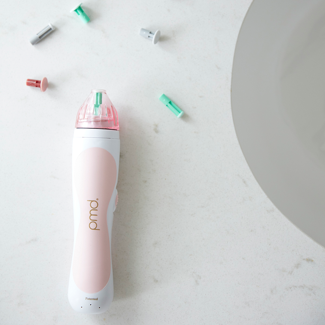 1203?Personal Microderm Classic in Blush on countertop surrounded by discs