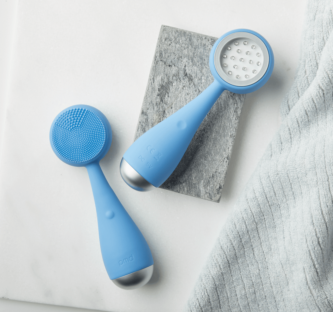 PMD Clean Acne facial cleansing brush with antibacterial silicone and blue LED light technology, designed to deeply cleanse skin and target acne-causing bacteria.