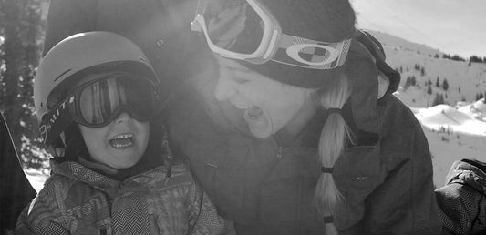 Jessica with young son skiing