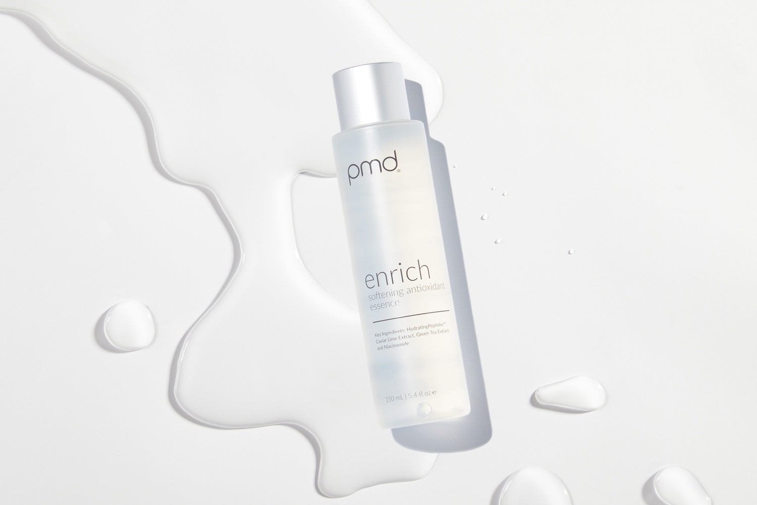 enrich essence bottle on white background with essence spilled out