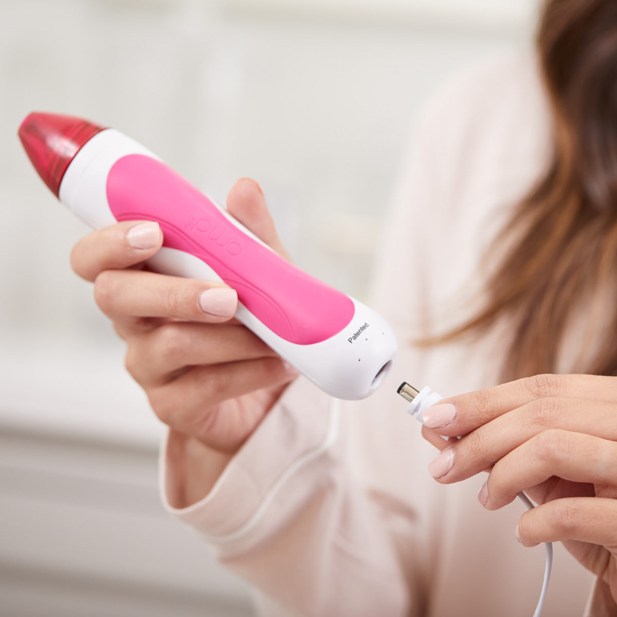 plugging cord into bottom of personal microderm