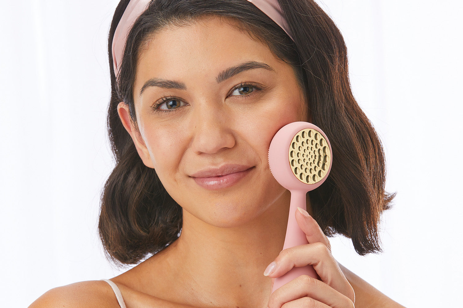 woman using PMD Clean Pro Gold