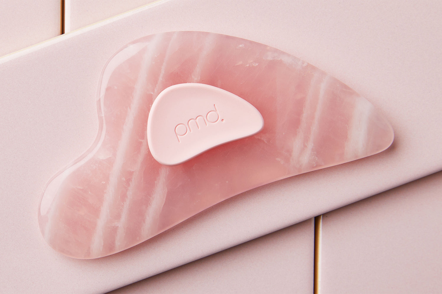 pmd gua sha on blush tile