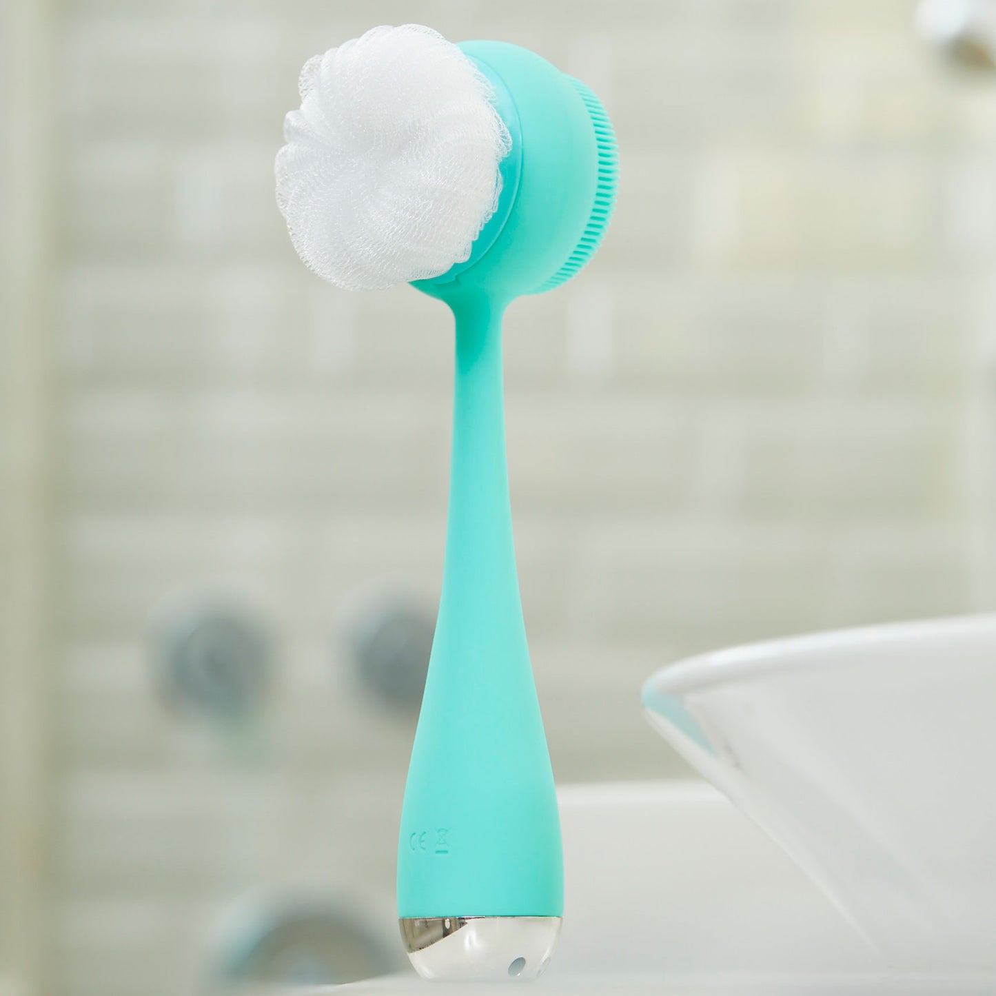4003-Teall?PMD Clean Body in teal in bathroom showing loofah attachment