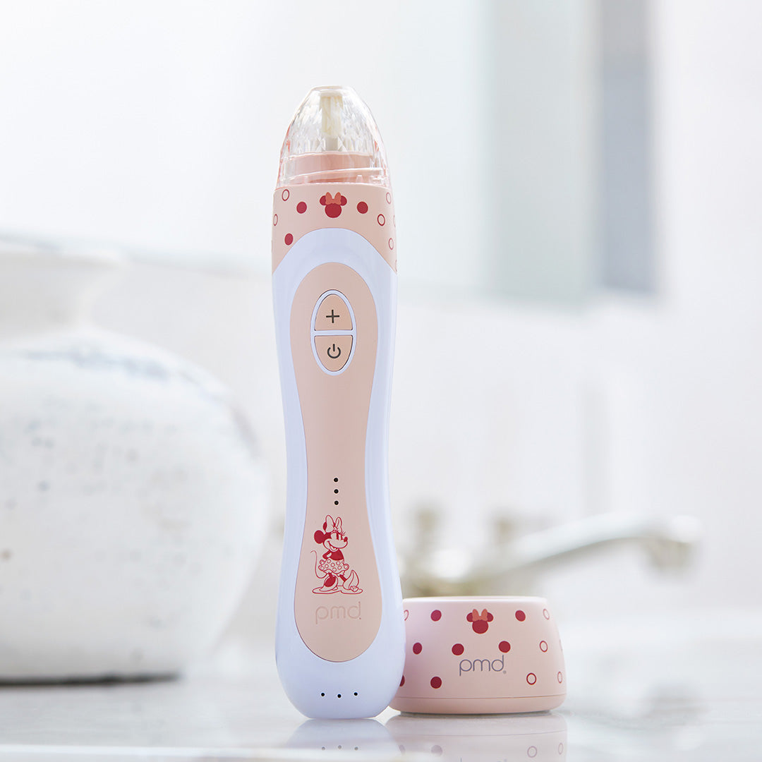 1005-MAUVE-MIN? Minnie Mouse Personal Microderm Elite Pro Being on counter with charger