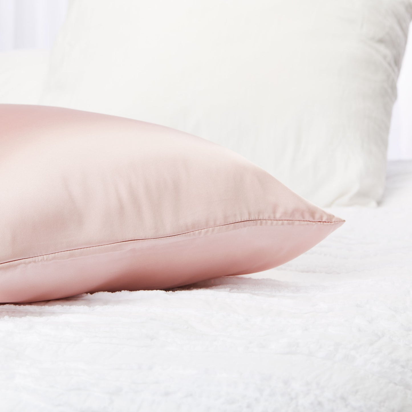 449270?Closeup of silversilk pillowcase in rose on bed