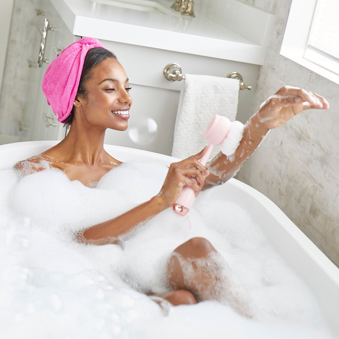 4003-Blush?Woman in tub using PMD Clean Body loofah attachment to cleanse her body