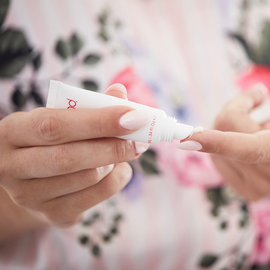 1026?Woman putting lip serum on to finger