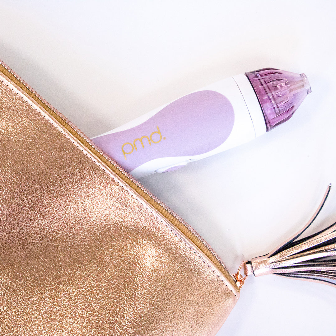 1001-LPur?Personal Microderm Classic in lavender peeking out of a rose gold Kennedy makeup bag