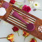 4003-Berry?PMD Clean Body in berry on bath tray surrounded by flowers